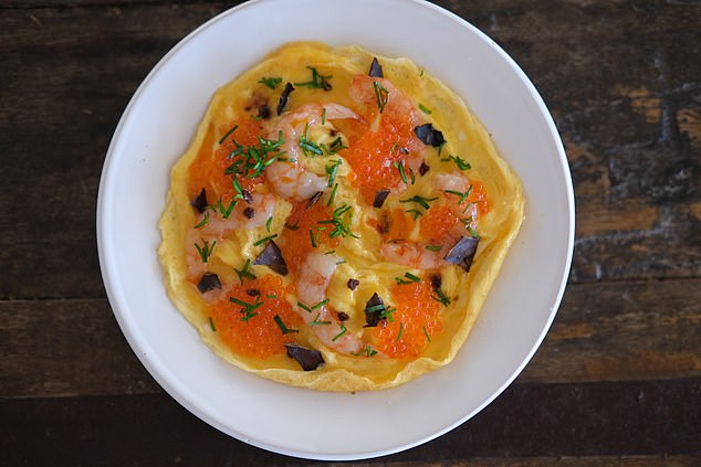 Nudo¿s open omelette ¿is scattered with prawns and trout roe, like glittering orange gems'