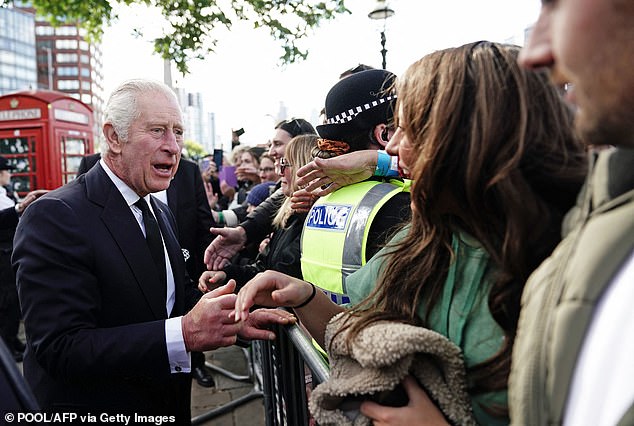 King Charles chats with the crowds waiting to walk by the Queen's coffin in Westminster Abbey to pay their respects